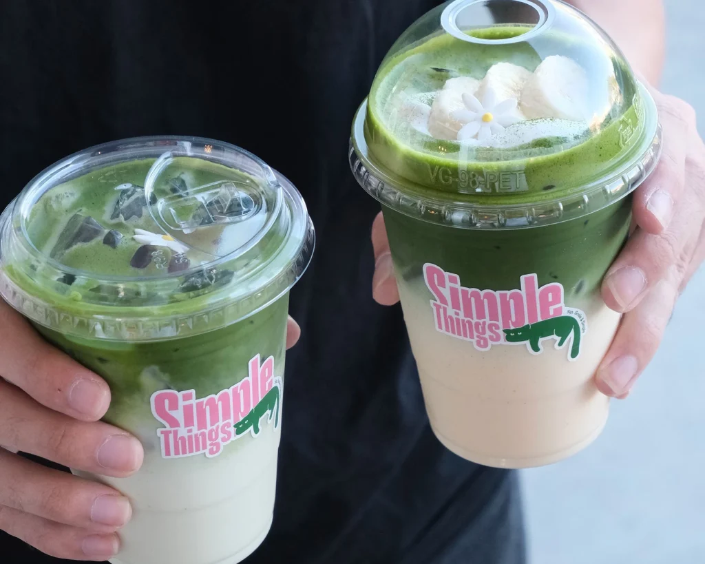 A freshly prepared matcha drink in a ceramic cup.